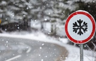 Winter mountains road with sign of snow