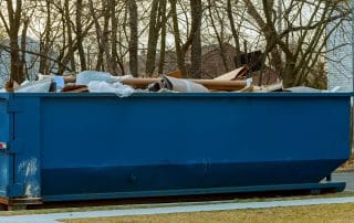 Full dumpster outside of a home