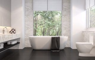 Residential bathroom with sink, toilet and bathtub