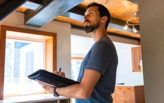 Man taking notes performing a home inspection
